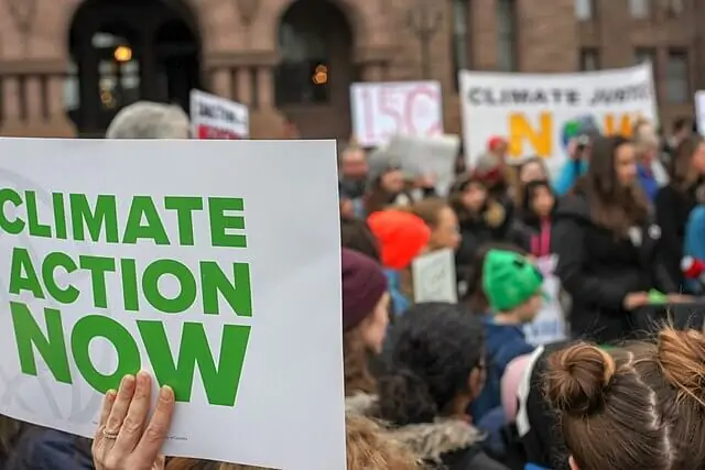 Public demonstration calling for urgent climate action with protest signs