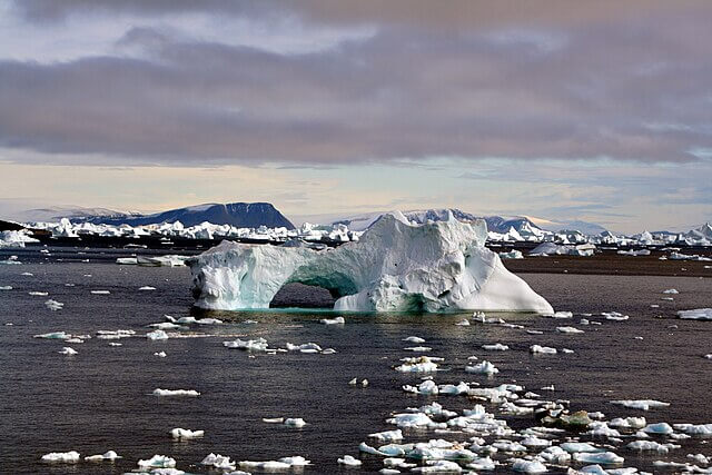 Melting iceberg in polar waters symbolising accelerating ice loss from global heating