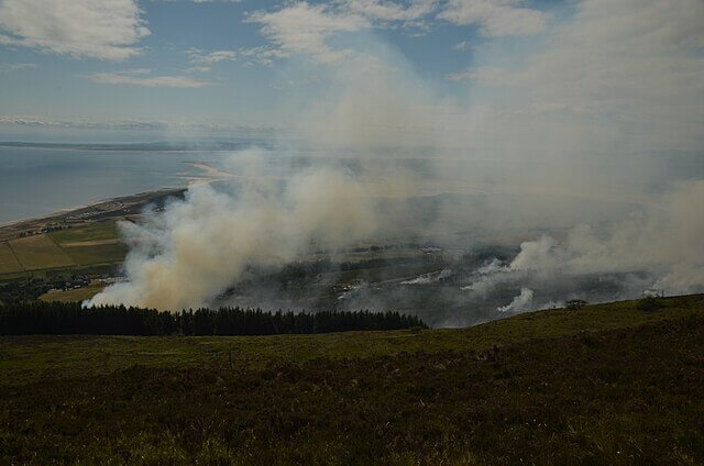 Burning moorland illustrating the importance of healthy peat and moss for wildfire prevention