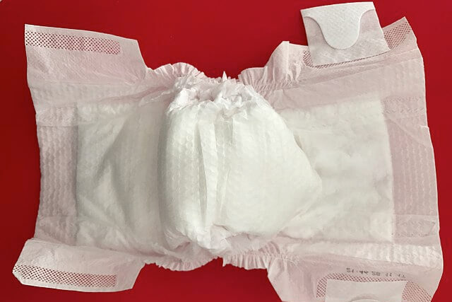 Disposable baby nappy showing the everyday waste created by single-use childcare products
