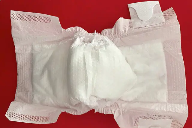 Disposable baby nappy showing the everyday waste created by single-use childcare products