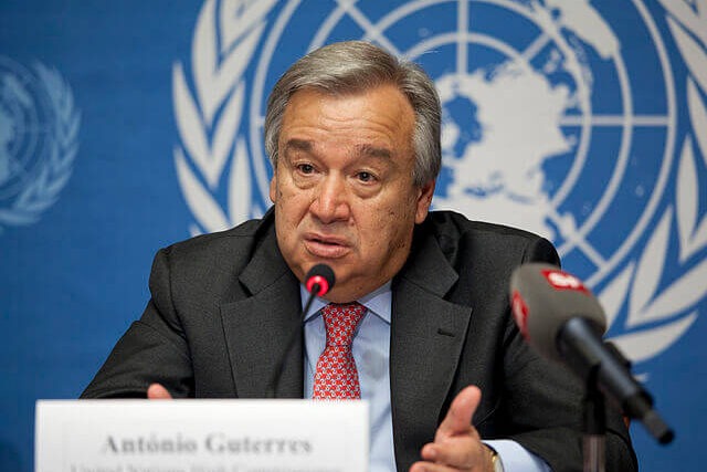 António Guterres, UN Secretary-General, speaking at a podium during a United Nations conference on global economic reform and climate action.