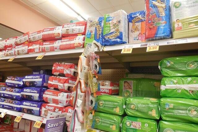 Packets of disposable nappies on supermarket shelves highlighting consumer demand and nappy waste