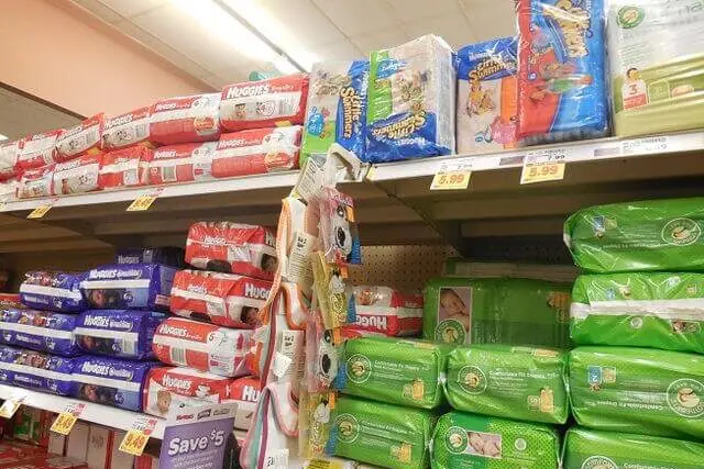 Packets of disposable nappies on supermarket shelves highlighting consumer demand and nappy waste