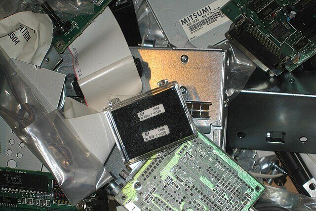 Pile of discarded electronic devices including smartphones, computers and televisions, illustrating growing global e-waste pollution.