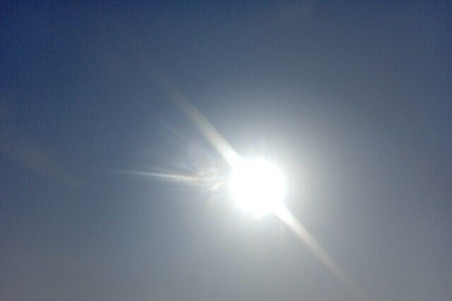 Bright sun shining in a clear blue sky during a heatwave