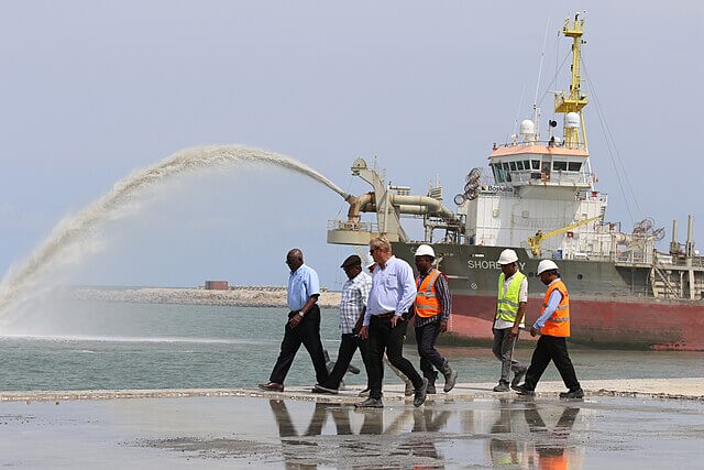 Industrial sand dredging vessel extracting sand from Lagos Lagoon, Nigeria, contributing to coastal erosion and environmental impact
