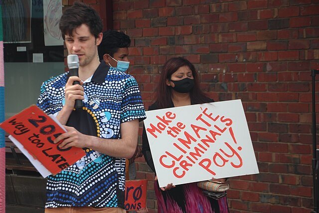 Climate protesters in the United States holding signs calling for action on global warming and fossil fuels
