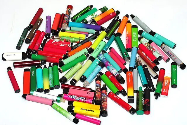 Pile of colourful disposable vapes showing the scale of UK vape waste
