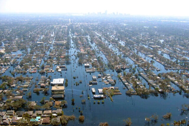 Widespread flooding in New Orleans following Hurricane Katrina, with submerged streets and damaged buildings across the city.