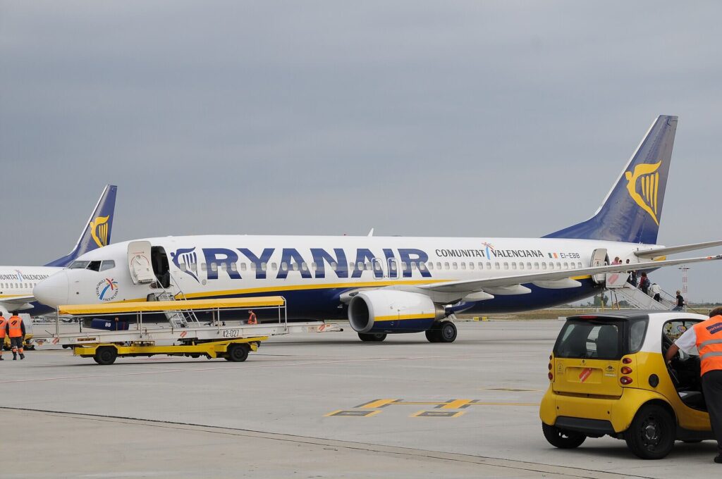 Ryanair passenger aircraft parked at airport terminal amid growing concerns over aviation emissions in Europe