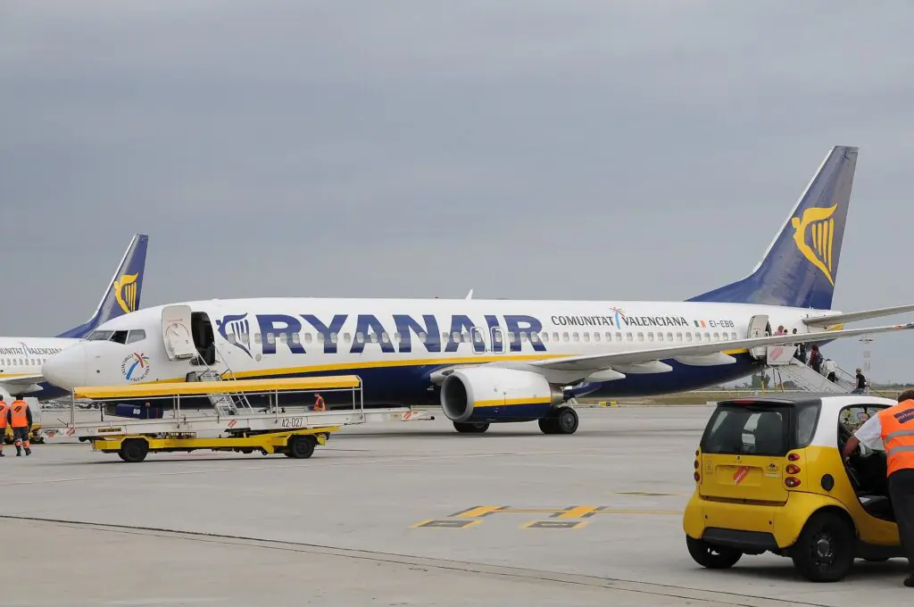 Ryanair passenger aircraft parked at airport terminal amid growing concerns over aviation emissions in Europe