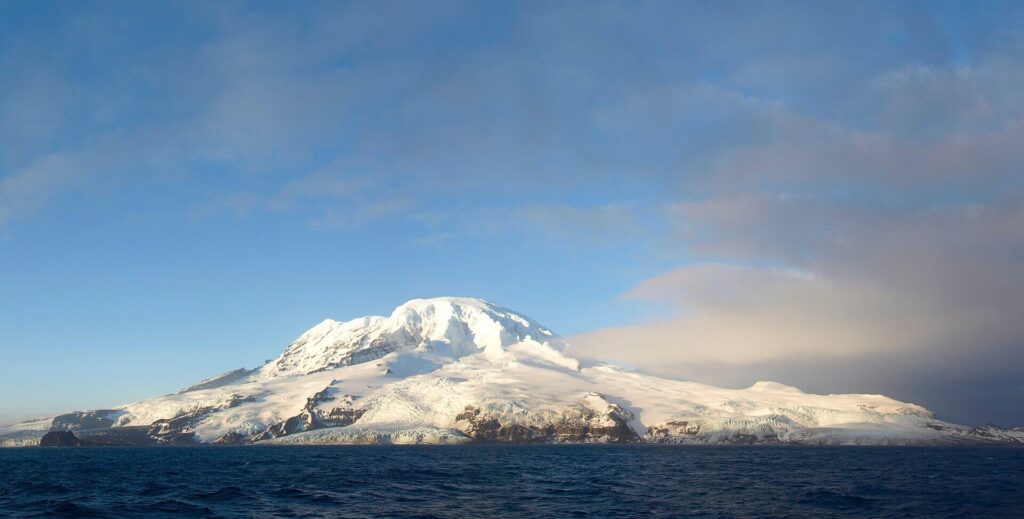 Remote Antarctic landscape of Heard Island with icy coastline, glaciers and seabird colonies in a sub-Antarctic environment