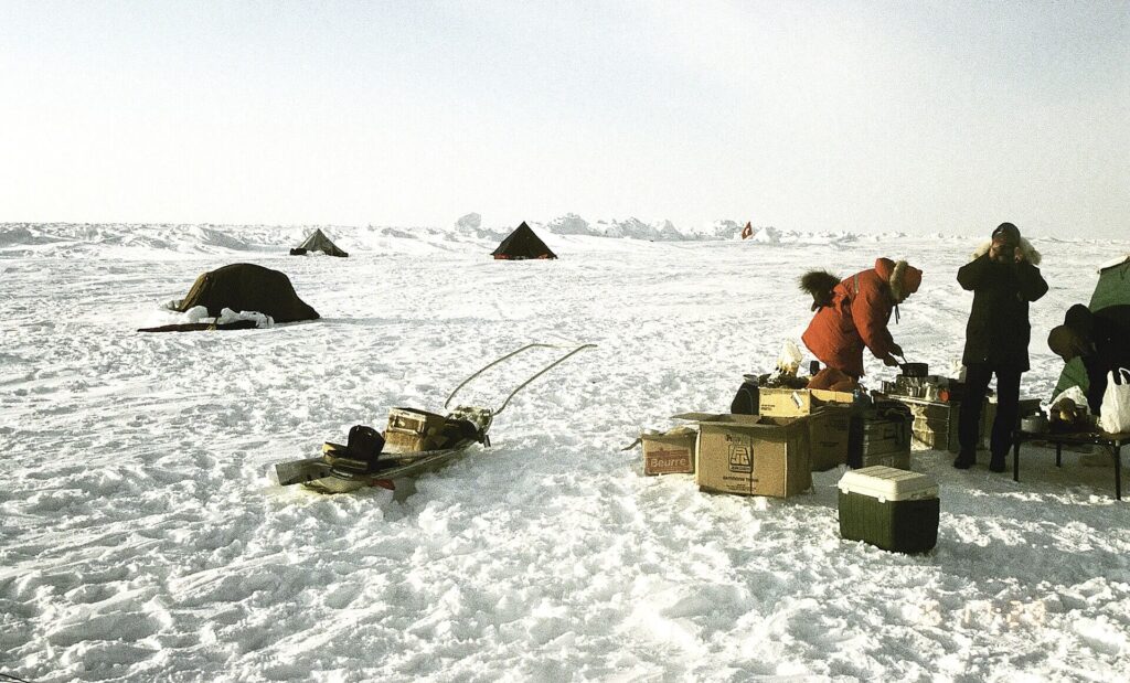 Scientists conducting research on Arctic sea ice during climate change fieldwork