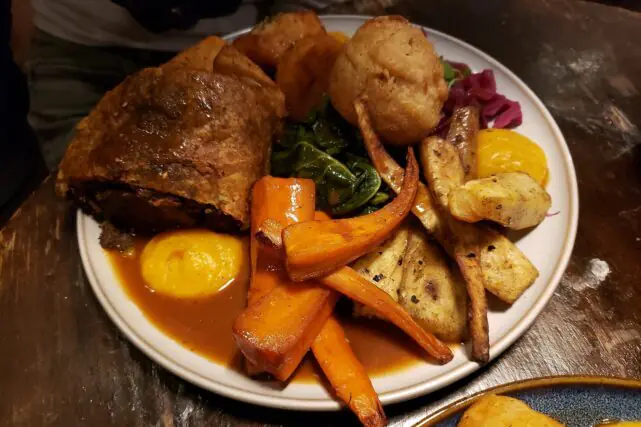 Traditional Sunday roast meal served with vegetables, representing UK food culture and farming supply chains.