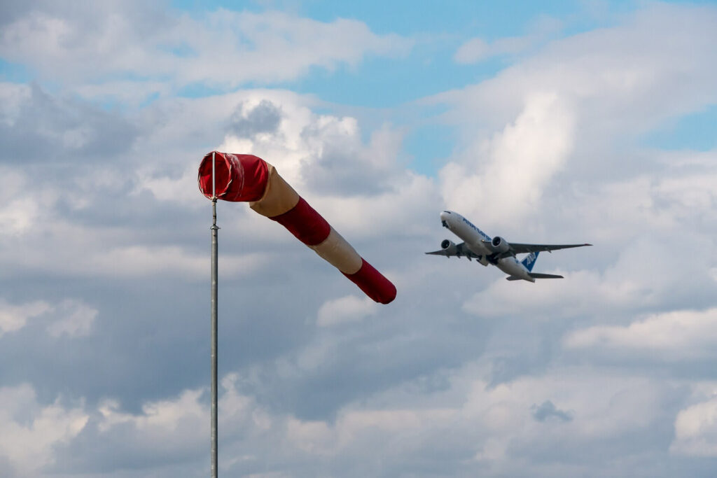 Passenger jets in the sky showing air travel and aviation industry emissions context
