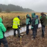 Inspecting river with community members