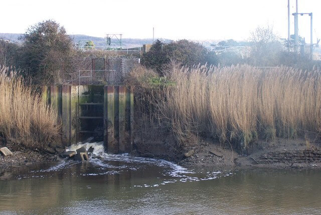 Wastewater discharge from a sewage outfall into a river