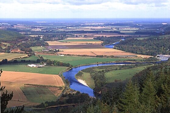 Farmland surrounding a river in the UK, highlighting agriculture near freshwater habitats